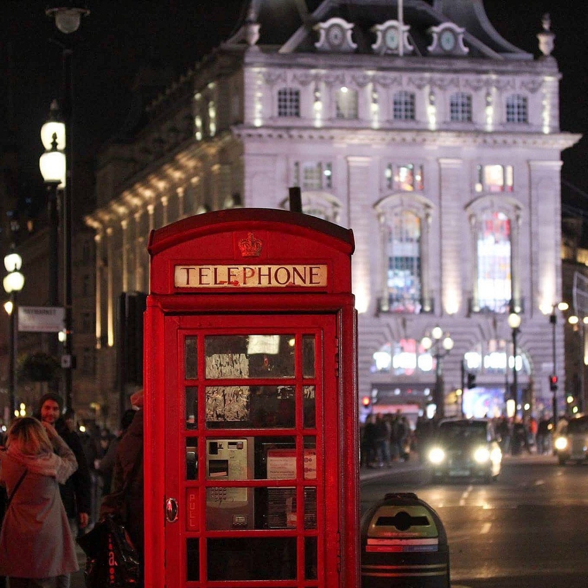 Red telephone box in London at night